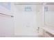 Clean, all-white shower/tub combination with swan accent and silver hardware at 6513 Hyde Ave, Las Vegas, NV 89107
