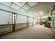 Enclosed sun room with carpet flooring, white lattice, and natural light at 6513 Hyde Ave, Las Vegas, NV 89107