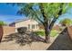 Backyard putting green shaded by mature trees, desert landscaping, rock and block wall at 6656 Arctic Breeze St, North Las Vegas, NV 89084