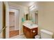 Bathroom with wood vanity and wood-look tile flooring at 6656 Arctic Breeze St, North Las Vegas, NV 89084