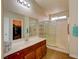 Bathroom featuring a vanity, mirror, glass-enclosed shower, and a view of a closet with ample storage at 6656 Arctic Breeze St, North Las Vegas, NV 89084