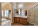Bathroom featuring a vanity, large mirror, and a glass-enclosed shower, offering a clean and functional space at 6656 Arctic Breeze St, North Las Vegas, NV 89084