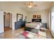 Well-lit bedroom with vaulted ceilings, tile floors, and a full set of furniture, including a dresser and nightstands at 6656 Arctic Breeze St, North Las Vegas, NV 89084