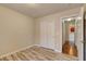 Neutral bedroom with closet and wood-look tile flooring at 6656 Arctic Breeze St, North Las Vegas, NV 89084