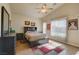 Bright bedroom featuring a ceiling fan, neutral walls, tile flooring, and a large window with a view of the outdoors at 6656 Arctic Breeze St, North Las Vegas, NV 89084