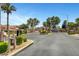 Gated community entrance with well-maintained landscaping and mature palm trees at 6656 Arctic Breeze St, North Las Vegas, NV 89084
