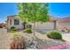 Charming single-story home featuring a well-manicured front yard and a welcoming two-car garage at 6656 Arctic Breeze St, North Las Vegas, NV 89084