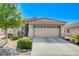 Inviting single-story home with a spacious two-car garage and a neatly landscaped front yard at 6656 Arctic Breeze St, North Las Vegas, NV 89084