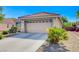 Nice single-story home with a convenient two-car garage, desert landscaping, and a paved driveway at 6656 Arctic Breeze St, North Las Vegas, NV 89084