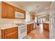 Lovely kitchen with classic wood cabinets, smooth countertops, and an open view into the dining space at 6656 Arctic Breeze St, North Las Vegas, NV 89084