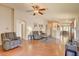 Open floor plan living room with hardwood floors, ceiling fan, and neutral paint at 6656 Arctic Breeze St, North Las Vegas, NV 89084