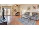 Bright living room with hardwood floors, ceiling fan, and sliding door access at 6656 Arctic Breeze St, North Las Vegas, NV 89084