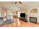 Inviting living room with a fireplace, ceiling fan, and hardwood floors at 6656 Arctic Breeze St, North Las Vegas, NV 89084