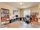 Office with desk, shelving, and wood-look tile flooring at 6656 Arctic Breeze St, North Las Vegas, NV 89084