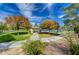 A gazebo and walking path in a well-maintained park surrounded by mature trees and landscaping on a sunny day at 6656 Arctic Breeze St, North Las Vegas, NV 89084