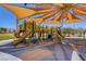 Community playground with multiple slides and shaded play area for  at 6656 Arctic Breeze St, North Las Vegas, NV 89084