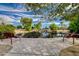 Scenic view of a pond with a small waterfall, surrounded by lush greenery and benches, perfect for relaxation at 6656 Arctic Breeze St, North Las Vegas, NV 89084