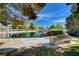Scenic view of a pond reflecting a clear blue sky, framed by trees and a bench, offering a serene outdoor space at 6656 Arctic Breeze St, North Las Vegas, NV 89084
