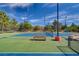 Well-kept tennis court with blue and green surface, benches, and surrounding greenery offering an active lifestyle at 6656 Arctic Breeze St, North Las Vegas, NV 89084