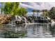 Scenic waterfall feature cascading into a pond, complemented by lush greenery and creating a tranquil environment at 6656 Arctic Breeze St, North Las Vegas, NV 89084