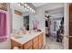 Inviting bathroom featuring a vanity, mirror, and an open doorway to the main bedroom at 700 Capri Dr # 27B, Boulder City, NV 89005