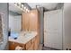 Bright bathroom with a mirrored vanity and wooden cabinets for ample storage at 700 Capri Dr # 27B, Boulder City, NV 89005