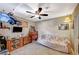 Spare bedroom with ceiling fan and eclectic decor, featuring a comfortable seating area at 700 Capri Dr # 27B, Boulder City, NV 89005