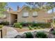 Inviting condo exterior with manicured landscaping and stairway access to the upper units at 700 Capri Dr # 27B, Boulder City, NV 89005