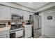 Updated kitchen with stainless steel appliances, white cabinets, and a gas range at 700 Capri Dr # 27B, Boulder City, NV 89005