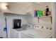 Functional laundry area featuring a washer, dryer, and shelving for storage at 700 Capri Dr # 27B, Boulder City, NV 89005