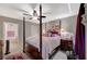 A calming main bedroom with a four-poster bed, ceiling fan, and a connecting bathroom at 700 Capri Dr # 27B, Boulder City, NV 89005