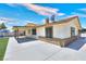 Exterior view of backyard with a concrete patio, covered entry, and spacious yard at 706 Red Lake Way, Las Vegas, NV 89110