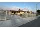 Exterior of the home with driveway, fencing and mountain views at 706 Red Lake Way, Las Vegas, NV 89110