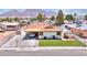 Exterior view of a charming home with a carport, RV parking, mountain views, and a green lawn at 706 Red Lake Way, Las Vegas, NV 89110
