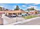 Beautiful exterior view showcasing the carport, fenced yard, and well-manicured lawn at 706 Red Lake Way, Las Vegas, NV 89110