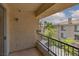 This condo balcony has iron railing with a view of palm trees, sidewalks, and building at 7155 S Durango Dr # 303, Las Vegas, NV 89113