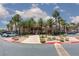 This lovely clubhouse is framed by lush palm trees, mature landscaping, and blue skies at 7155 S Durango Dr # 303, Las Vegas, NV 89113