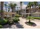 A walking path leads past BBQ grills and outdoor dining under shady pergola in a lush community at 7155 S Durango Dr # 303, Las Vegas, NV 89113