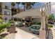 This community area offers BBQ grills and seating beneath a pergola surrounded by landscaping at 7155 S Durango Dr # 303, Las Vegas, NV 89113