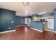Spacious open-plan living area features sleek flooring, blue walls and an open concept to the kitchen for modern living at 7155 S Durango Dr # 303, Las Vegas, NV 89113