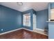Cozy living room with new flooring, a front door, and a view of the community landscape at 7155 S Durango Dr # 303, Las Vegas, NV 89113