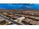 Aerial view of a neighborhood featuring single-story homes with desert landscaping and mountain views at 717 Monroe Hill Pl, Henderson, NV 89011
