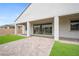 Inviting covered patio with brick pavers and an artificial lawn for outdoor enjoyment at 717 Monroe Hill Pl, Henderson, NV 89011