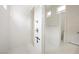Modern shower with sleek fixtures, white tile, and open access to additional bathroom area at 717 Monroe Hill Pl, Henderson, NV 89011