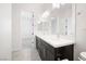 Bright bathroom featuring double sinks, contemporary fixtures and neutral toned flooring at 717 Monroe Hill Pl, Henderson, NV 89011