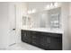 Elegant bathroom with double sinks, dark cabinetry, and sleek lighting fixtures at 717 Monroe Hill Pl, Henderson, NV 89011