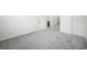 Spacious carpeted bedroom with baseboards, white walls and access to the bathroom and hallway at 717 Monroe Hill Pl, Henderson, NV 89011