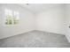 Well-lit bedroom with plush carpeting and a bright window offering natural lighting at 717 Monroe Hill Pl, Henderson, NV 89011
