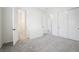 Open bedroom with bathroom access, soft carpet and multiple doors at 717 Monroe Hill Pl, Henderson, NV 89011