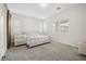 Bright bedroom featuring carpet flooring, baseboards, large window with great lighting and neutral wall color at 717 Monroe Hill Pl, Henderson, NV 89011